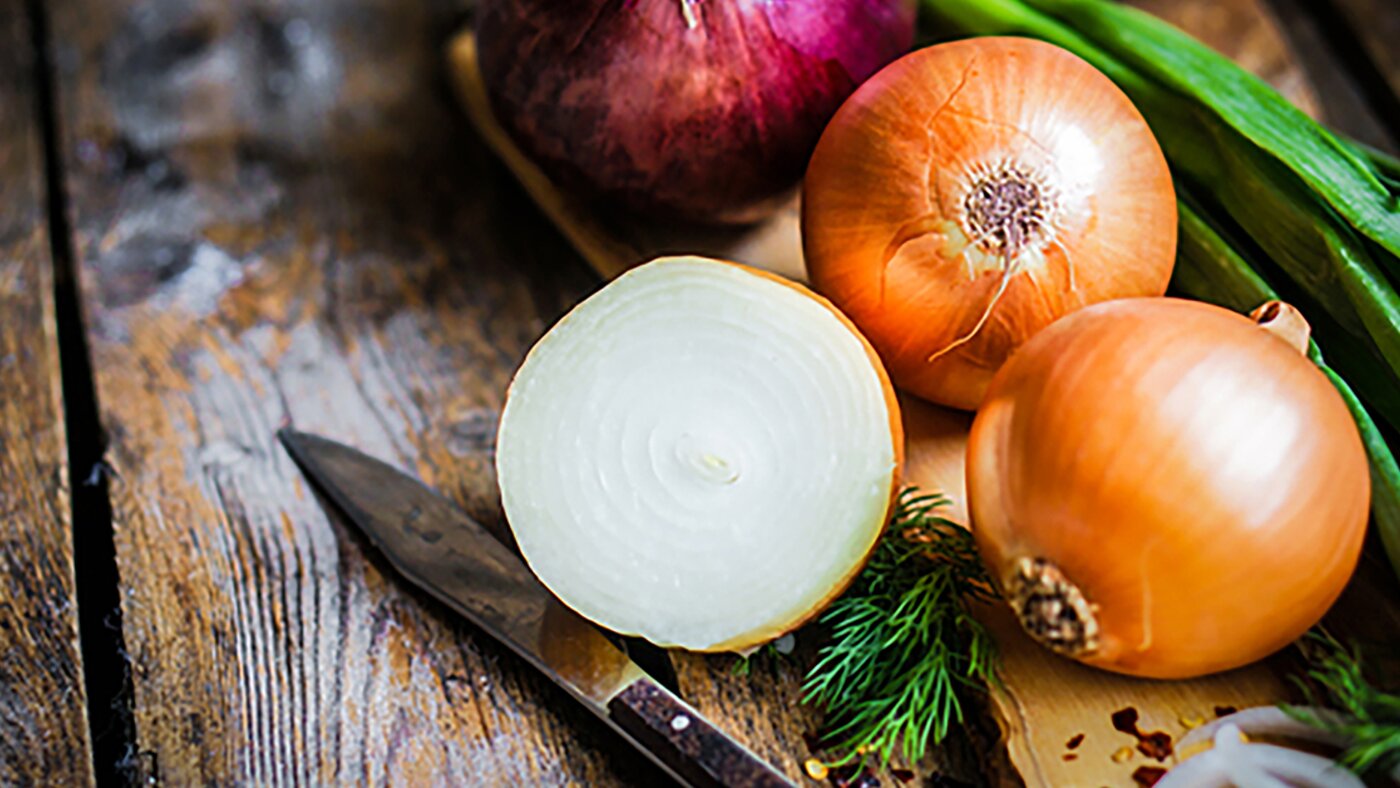 Yellow and red onions on chopping board