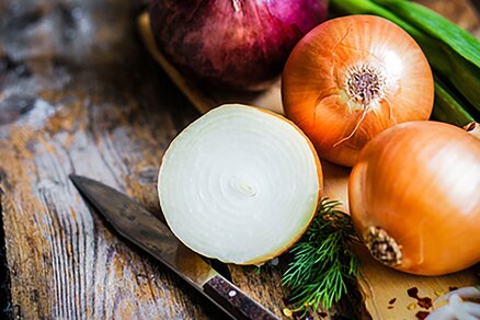 Yellow and red onions on chopping board