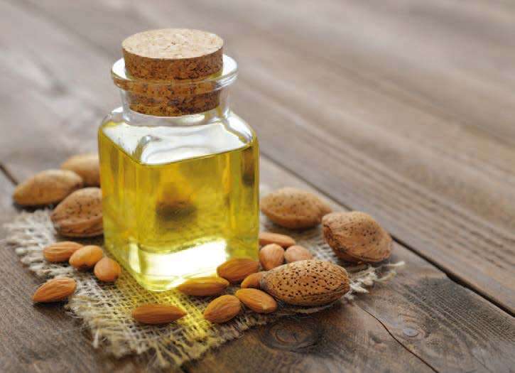 Huile d'amande en flacon, amandes mondées et non mondées