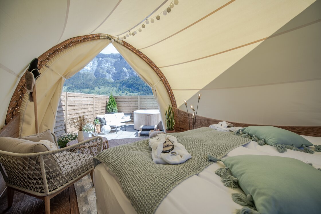 Blick von Bett in Luxus-Zelt auf Berge